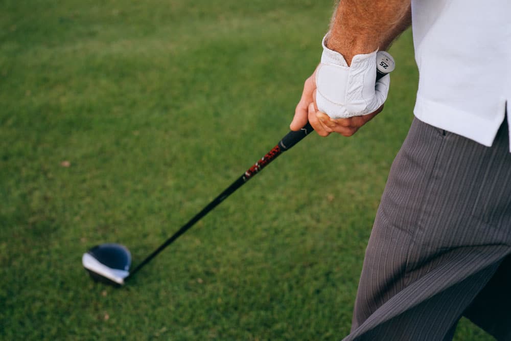 Image of man gripping golf club